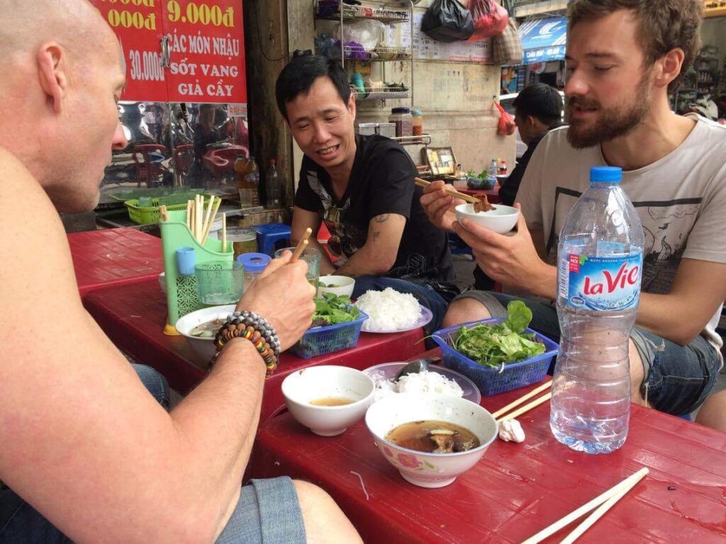 Me eating street food in Hanoi, the capital of Vietnam